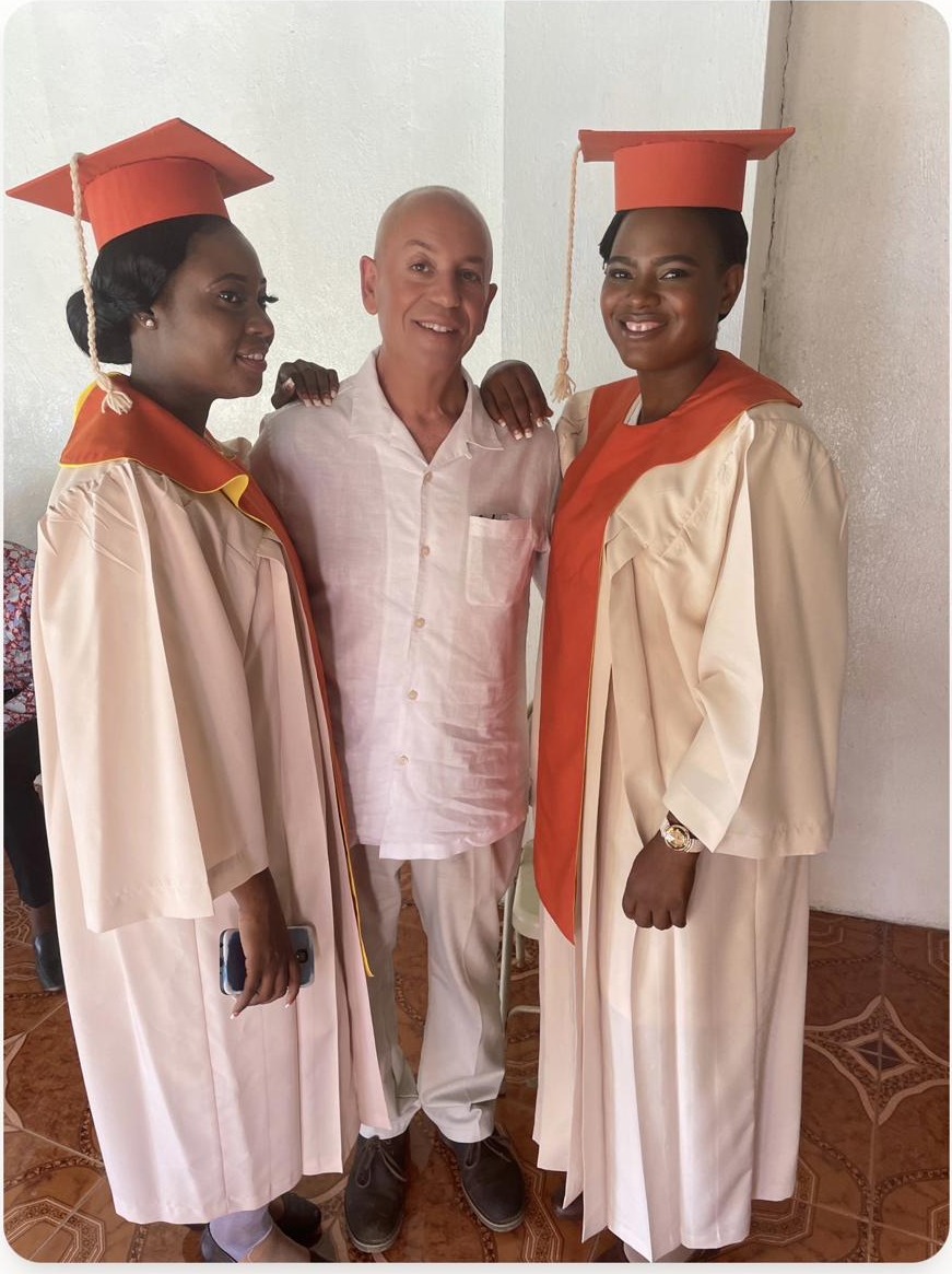Randy Moore with two students at their graduation in Cap-Haïtien